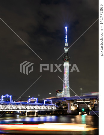 Night view of Tokyo Skytree, with beautiful reflections of the majestic tower in the Sumida River, it's the primary television and radio broadcast site in the Kanto region, Japan. Night view of Tokyo Skytree, with beautiful reflections of the majestic tower in the Sumida River, it's the primary television and radio broadcast site in the Kanto region, Japan. 141772869