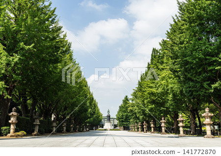 View of the causeway at the Yasukuni Shrine in Chiyoda, Tokyo, Japan. Neatly arranged stone lanterns on both sides. View of the causeway at the Yasukuni Shrine in Chiyoda, Tokyo, Japan. Neatly arranged stone lanterns on both sides. 141772870