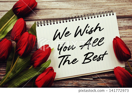 We Wish You All The Best text written on notepad with flower decoration on wooden background We Wish You All The Best text written on notepad with flower decoration on wooden background 141772973