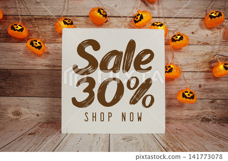Halloween Sale 30% text with Halloween decoration on wooden background Halloween Sale 30% text with Halloween decoration on wooden background 141773078