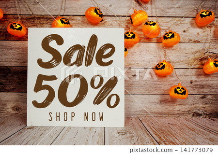 Halloween Sale 50% text with Halloween decoration on wooden background Halloween Sale 50% text with Halloween decoration on wooden background 141773079