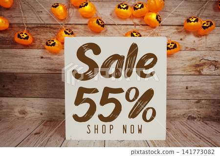 Halloween Sale 55% text with Halloween decoration on wooden background Halloween Sale 55% text with Halloween decoration on wooden background 141773082