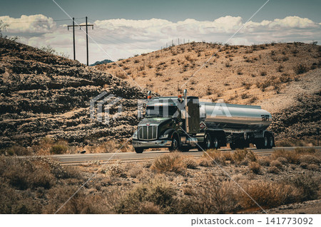 A roadside scene of a highway and convoy of cars running through the vast desert landscape of Arizona. A roadside scene of a highway and convoy of cars running through the vast desert landscape of Arizona. 141773092