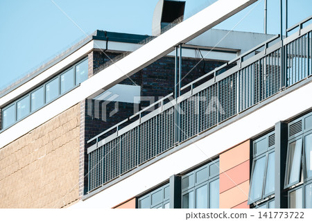 Modern apartment building facade with balconies and contemporary architecture Modern apartment building facade with balconies and contemporary architecture 141773722
