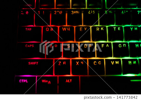 Top view of colorful RGB backlit keyboard glowing with vibrant LED lighting, showcasing modern computer hardware, gaming technology, digital workspace and neon illumination theme Top view of colorful RGB backlit keyboard glowing with vibrant LED lighting, showcasing modern computer hardware, gaming technology, digital workspace and neon illumination theme 141773842