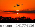 Bizjet take off against the backdrop of crimson sunrise 141774136