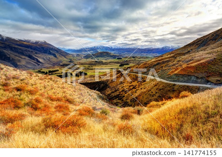 Mountain Valley Panorama with Autumn Grass and Stormy Sky Mountain Valley Panorama with Autumn Grass and Stormy Sky 141774155