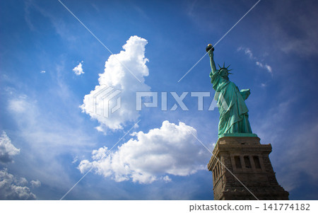 Statue of Liberty Against Blue Sky and Clouds Statue of Liberty Against Blue Sky and Clouds 141774182