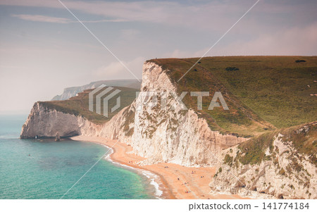 White Chalk Cliffs and Turquoise Sea on Scenic Coastal Beach 141774184