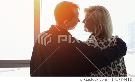 Couple Shares Peaceful Sunset With City Backdrop. Romantic Evening Scene Featuring Lovers By Luminous City Horizon. Quiet Moment Of Affection Captured During Sunset Behind Vibrant City Skyline Couple Shares Peaceful Sunset With City Backdrop. Romantic Evening Scene Featuring Lovers By Luminous City Horizon. Quiet Moment Of Affection Captured During Sunset Behind Vibrant City Skyline 141774418