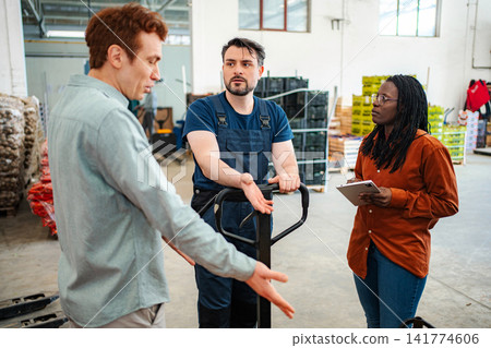 Warehouse colleagues having serious discussion about logistics problem Warehouse colleagues having serious discussion about logistics problem 141774606