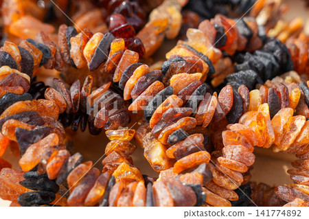 Raw Natural Baltic Amber Bracelets Made from Unpolished Amber Chips at Traditional Craft Market Display 141774892