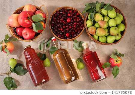 Apples, pears and cherries in baskets with bottles of cider, compote, and mulled wine, a Thanksgiving backdrop and a rustic harvest, concept of healthy natural food and home canning, Apples, pears and cherries in baskets with bottles of cider, compote, and mulled wine, a Thanksgiving backdrop and a rustic harvest, concept of healthy natural food and home canning, 141775078