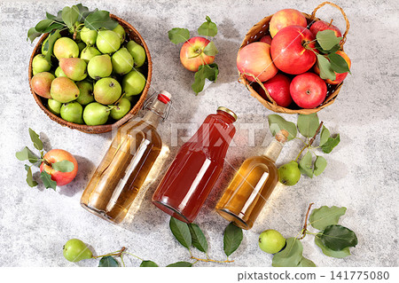 Apples, pears in baskets with bottles of cider and mulled wine, a Thanksgiving backdrop and a rustic harvest, concept of healthy natural food and home canning, longterm storage at home, Apples, pears in baskets with bottles of cider and mulled wine, a Thanksgiving backdrop and a rustic harvest, concept of healthy natural food and home canning, longterm storage at home, 141775080