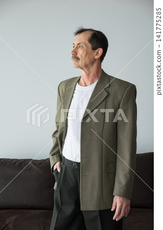 Caucasian Man Seated On Sofa, Contemplative Gaze And Gentle Posture Conveying Quiet Reflection Retired Professional Recalling Memories And Weighing Future Plans In Minimal Indoor Setting With Soft Caucasian Man Seated On Sofa, Contemplative Gaze And Gentle Posture Conveying Quiet Reflection Retired Professional Recalling Memories And Weighing Future Plans In Minimal Indoor Setting With Soft 141775285