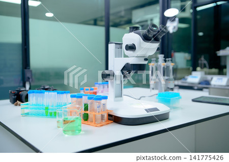 Laboratory Microscope Setup with Test Tubes and Chemical Solutions Laboratory Microscope Setup with Test Tubes and Chemical Solutions 141775426