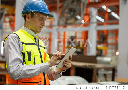 Quality Control Engineer Inspecting Large Industrial Steel Pipe Using Digital Tablet. Quality Control Engineer Inspecting Large Industrial Steel Pipe Using Digital Tablet. 141775442