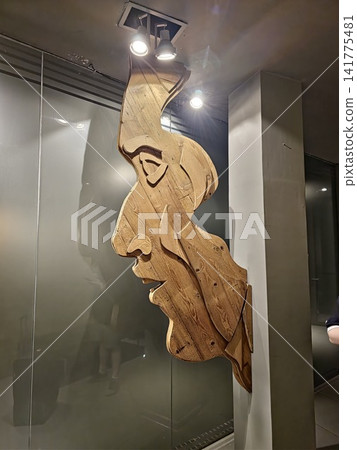 Buenos Aires, Argentina - March 29, 2026: Contemporary Wooden Sculpture Displayed Under Spotlights Buenos Aires, Argentina - March 29, 2026: Contemporary Wooden Sculpture Displayed Under Spotlights 141775481