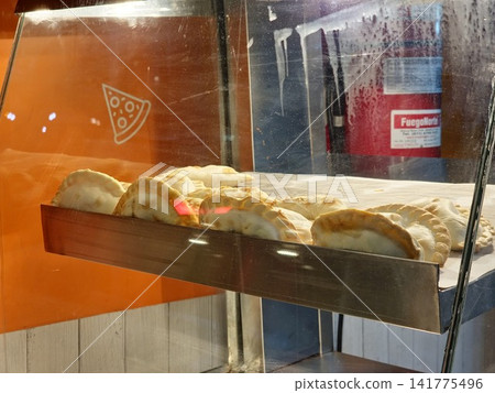 Buenos Aires, Argentina - March 28, 2026: Argentine Empanadas Displayed Behind Glass Counter Buenos Aires, Argentina - March 28, 2026: Argentine Empanadas Displayed Behind Glass Counter 141775496