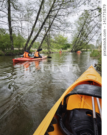 Kayakers in bright orange life jackets Kayakers in bright orange life jackets 141775879