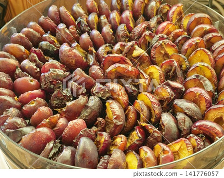 Plum Halves at Different Drying Stages on Round Dehydrator Tray Plum Halves at Different Drying Stages on Round Dehydrator Tray 141776057