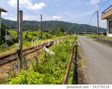 A landscape of Yazu Town, Yazu District, Tottori Prefecture, where a railway and a road run parallel. A landscape of Yazu Town, Yazu District, Tottori Prefecture, where a railway and a road run parallel. 141776119