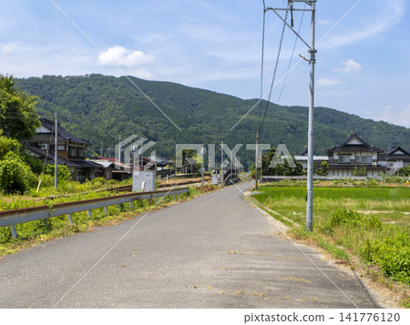 A landscape of Yazu Town, Yazu District, Tottori Prefecture, where a railway and a road run parallel. A landscape of Yazu Town, Yazu District, Tottori Prefecture, where a railway and a road run parallel. 141776120