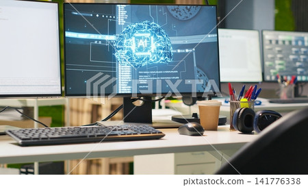 Close up of empty tech startup office with artificial intelligence program running on PC monitors. AI industry startup workspace leveraging machine learning technology, handheld camera shot Close up of empty tech startup office with artificial intelligence program running on PC monitors. AI industry startup workspace leveraging machine learning technology, handheld camera shot 141776338