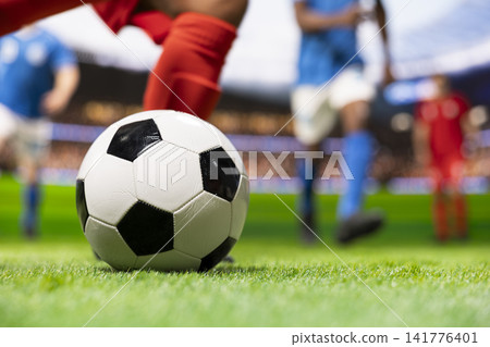 Close up of soccer player kicking ball in attack action running forward, breaking away on side run and shooting shot to score goal. Dynamic motion blur with dribble skill on pitch. Close up of soccer player kicking ball in attack action running forward, breaking away on side run and shooting shot to score goal. Dynamic motion blur with dribble skill on pitch. 141776401