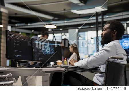 IT specialist in wheelchair using AI automation, refining algorithms for faster processing. Programmer with paraplegia in inclusive office using artificial intelligence for resource optimization IT specialist in wheelchair using AI automation, refining algorithms for faster processing. Programmer with paraplegia in inclusive office using artificial intelligence for resource optimization 141776446