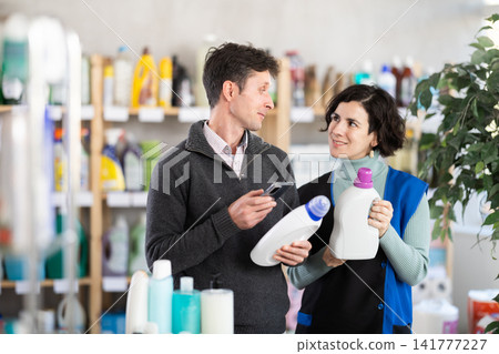 female seller helps the buyer with the choice of detergent female seller helps the buyer with the choice of detergent 141777227