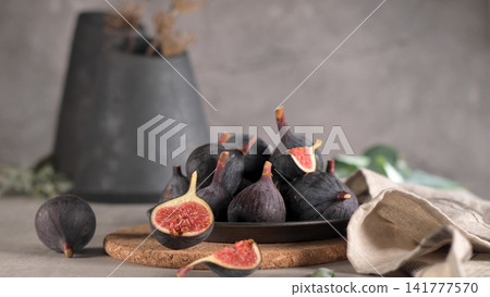 Succulent purple figs, some halved to reveal their vibrant red interior Succulent purple figs, some halved to reveal their vibrant red interior 141777570