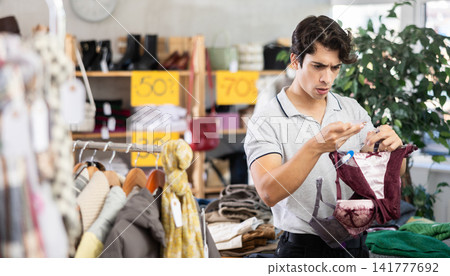In chain shop, man choose ladys lingerie bra In chain shop, man choose ladys lingerie bra 141777692