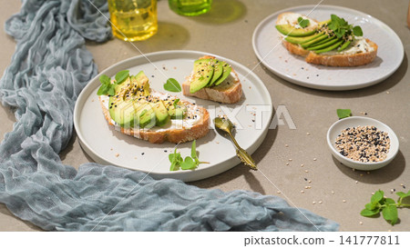 Toast with avocado cream cheese and wheat bread Toast with avocado cream cheese and wheat bread 141777811