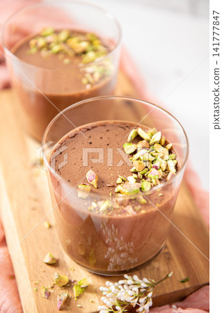 Two elegant glasses of smooth chocolate dessert Two elegant glasses of smooth chocolate dessert 141777847