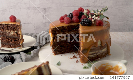 Chocolate Layer Cake with Caramel Drizzle and Fresh Berries Chocolate Layer Cake with Caramel Drizzle and Fresh Berries 141777967