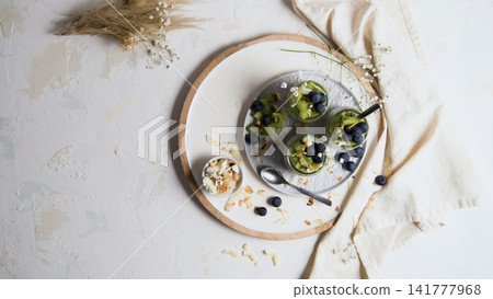 Healthy Fruit Parfait in Glass Jars with Kiwi and Blueberry Healthy Fruit Parfait in Glass Jars with Kiwi and Blueberry 141777968