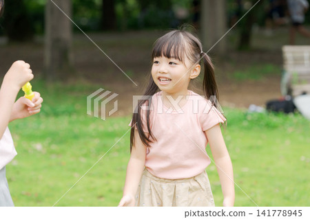 Sisters playing in a summer park Sisters playing in a summer park 141778945