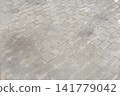 Cobblestone street with the first snowfall swirling around (background material) 141779042