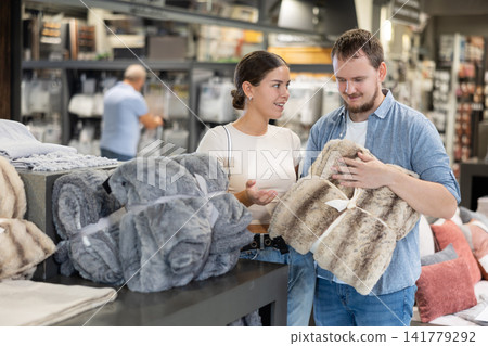 Husband and wife buy a warm blanket at hardware store Husband and wife buy a warm blanket at hardware store 141779292
