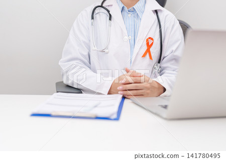 Professional doctor using laptop and writing notes for February World Cancer Day, September Leukemia, March Kidney, August Appendix, Multiple Sclerosis, November CRPS and COPD disease concept Professional doctor using laptop and writing notes for February World Cancer Day, September Leukemia, March Kidney, August Appendix, Multiple Sclerosis, November CRPS and COPD disease concept 141780495