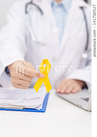 Doctor with Yellow Ribbon for concept of yellow September, Suicide prevention day, Childhood, July Sarcoma, bone and bladder cancer Awareness month, support survivor. Healthcare and World Cancer day Doctor with Yellow Ribbon for concept of yellow September, Suicide prevention day, Childhood, July Sarcoma, bone and bladder cancer Awareness month, support survivor. Healthcare and World Cancer day 141780527