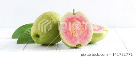 Fresh green and pink guava fruits with leaves on white background Fresh green and pink guava fruits with leaves on white background 141781771