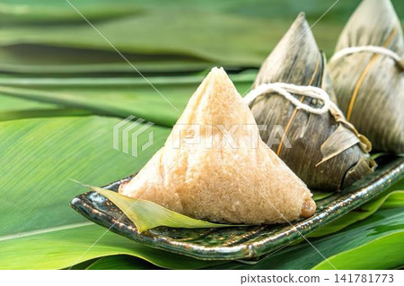 Fresh green mangoes on a black tray with banana leaves 141781773