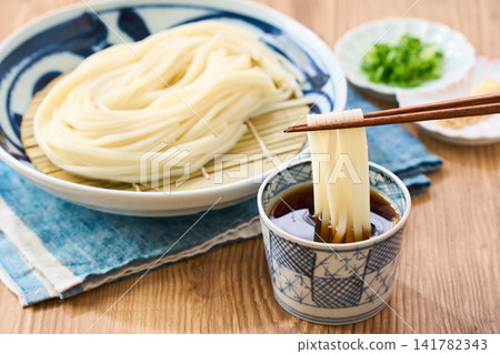 Zaru Udon: A cold noodle dish made with Sanuki udon noodles served on a plate. Zaru Udon: A cold noodle dish made with Sanuki udon noodles served on a plate. 141782343