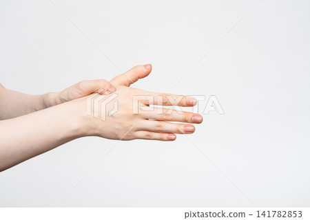 A woman's hands, placed on the back of her hands to warm them. A woman's hands, placed on the back of her hands to warm them. 141782853