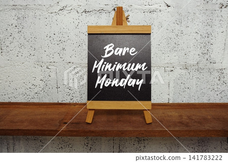 Bare Minimum Monday text written on easel blackboard Bare Minimum Monday text written on easel blackboard 141783222