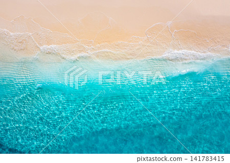 Serene beach from above soft waves washing powdery sand along turquoise tropical shore muted water gradient. Perfect summer travel seascape minimal design. Quiet outdoors wellness copy space scenic Serene beach from above soft waves washing powdery sand along turquoise tropical shore muted water gradient. Perfect summer travel seascape minimal design. Quiet outdoors wellness copy space scenic 141783415
