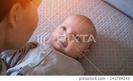 Young mother bonding with her smiling newborn baby Young mother bonding with her smiling newborn baby 141784148