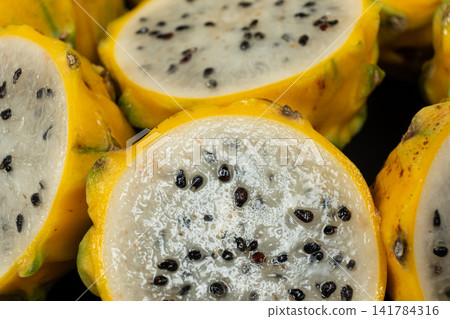 Cut ripe yellow pitahaya fruits close up view. Cut ripe yellow pitahaya fruits close up view. 141784316
